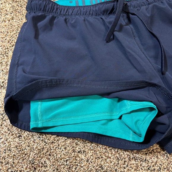 Nike Dri-FIT running shorts in navy blue with a teal waistband and trim large - Picture 2 of 5